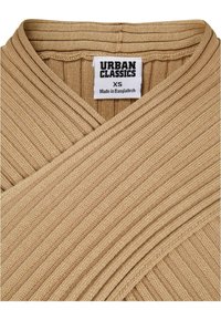 Top avvolgente color tan realizzato in tessuto a costine. Presenta una profonda scollatura a V e pannelli frontali sovrapposti. L'etichetta riporta "URBAN CLASSICS" con taglia XS.