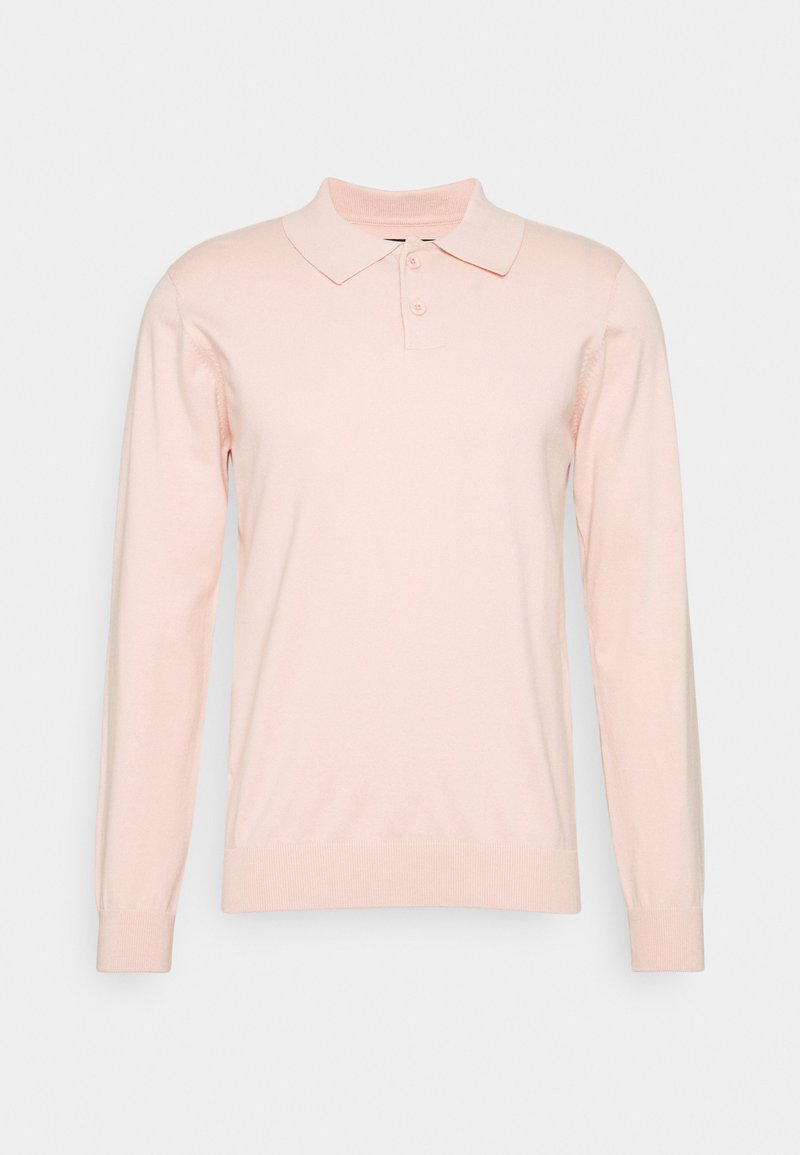 Langærmet polo-shirt i blød lyserød, fremstillet af letvægtsstof. Har en krave, tre knapper samt ribbede manchetter og afslutning.