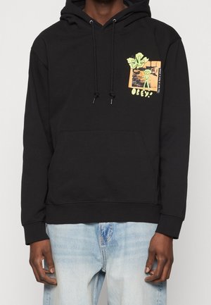 Hoodie noir en coton, avec une poche frontale. Comprend un graphisme coloré sur la poitrine avec un alien et le texte "OBEY !" en jaune.