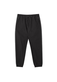 Svarta träningsbyxor med elastisk midja, dragsnodd, sidofickor och vita ränder längs sidorna. Lättviktsmaterial och avsmalnande design.