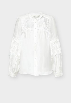 Pikkade varrukatega valge pluus, millel esiosas nööbid, pitsdetailid ülaseljal ja varrukatel ning kätiste kogutud servad.