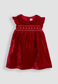 Rotes Samtkleid mit kurzen gerafften Ärmeln, einem runden Kragen und dekorativer Raffung mit weißen Sternen entlang des Oberkörpers. Knopfverschluss auf der Rückseite.