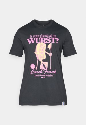 Black cotton t-shirt featuring a playful graphic of a hotdog character in pink, with text about golfing and Coach Frank. Short sleeves and crew neck.