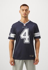 Sötétkék NFL mez 4-es számmal, szürke csíkozással és csillagmintával a ujjakon; könnyű anyagból készült.