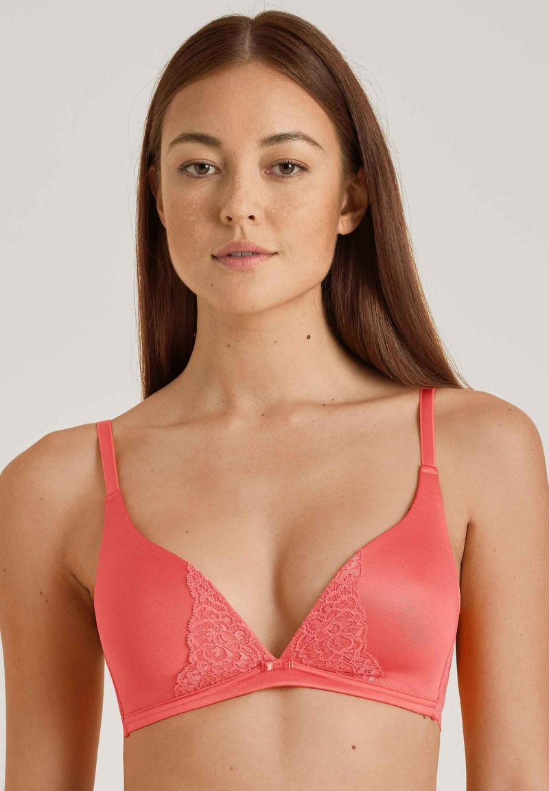 Coral bra with a triangular shape, featuring lace detailing on the cups, adjustable straps, and a smooth texture.