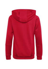 Felpa rossa con tessuto testurizzato, dotata di cappuccio con cordino, maniche lunghe e una vestibilità leggermente aderente in vita e ai polsini.