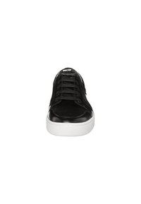 Black sneaker with a smooth leather toe cap and textured suede upper, featuring black laces and a white rubber sole. Simple, modern design.