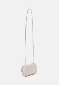 Small rectangular bag in soft beige material. Features a gold chain strap and rounded edges, with a smooth texture and minimalistic design.