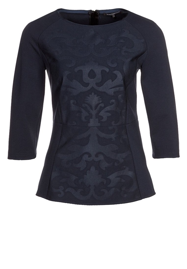 Marinblus med trekvartslånga ärmar, texturerad yta med en subtil damaskmönster, rundad halsringning och bakre dragkedjedetalj.