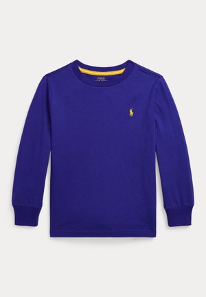 Langærmet lilla skjorte lavet af bomuld med rund hals. Har en lille gul polo-logo på brystet og ribkanter ved ærmerne.