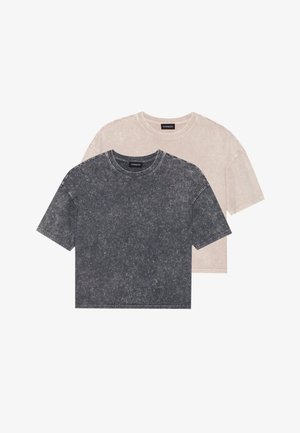 Du sienos trumpomis rankovėmis, apvaliu kaklu T marškiniai nublukusios juodos ir šviesiai smėlinės spalvos. Minkšta, tekstūruota medžiaga su laisvu kirpimu ir matomomis siuvimo detalėmis.