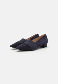 Navy blue suede flats with pointed toes and a wide fabric accent band across the midfoot, featuring a low block heel.