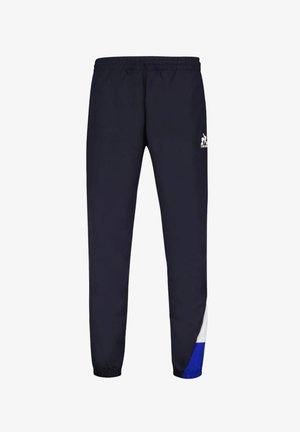 Jogging en marine avec taille élastique. Présente des accents blancs et bleus sur les côtés inférieurs. Fabriqué à partir d'un tissu lisse et respirant.