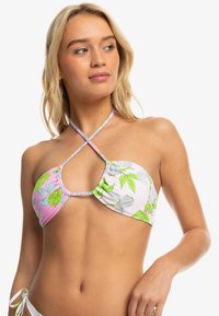 Bikini top with floral pattern in pink, white, and green. Features cross-back straps and soft, ruched fabric. Adjustable fit.