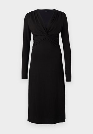 Black long-sleeve dress with a deep V-neck and twisted bodice detail. Designed in a smooth, stretchy fabric for comfort and fit.