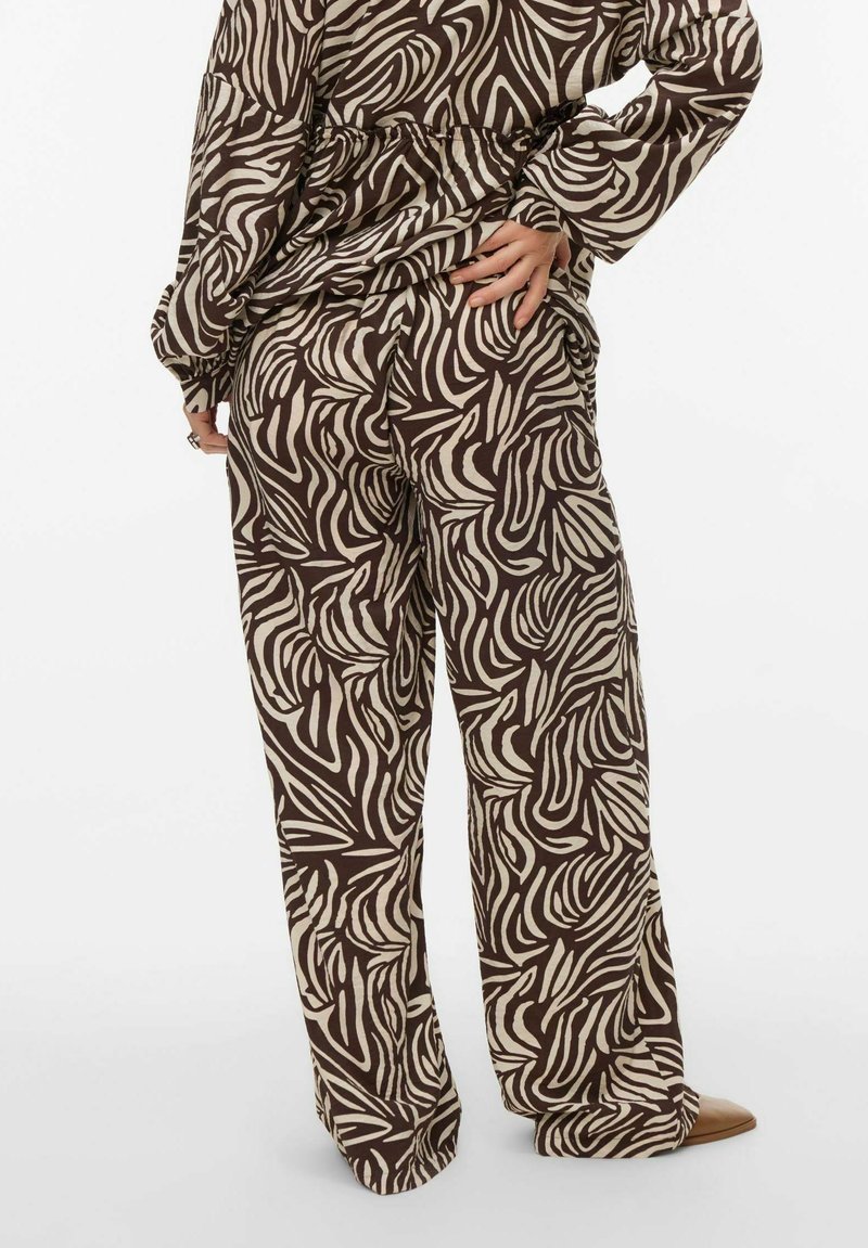 Brūnas un krēmkrāsas platām kājām bikses ar rakstu, izgatavotas no mīksta auduma, ar vērpjošu dizainu un vaļīgu piegriezumu ar aukliņu viduklī.