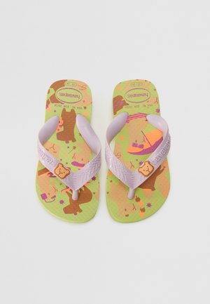 Purple flip-flops with a textured strap and a green sole featuring colorful animal patterns, stars, and the brand name "Havaianas."