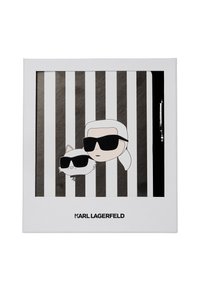 Fashion-themed notebook featuring a black and white striped design, illustrations of a character and a cat in sunglasses, with a silver accent pen included.