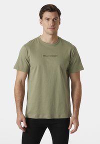 Helly Hansen CORE - Triko s potiskem - lav green