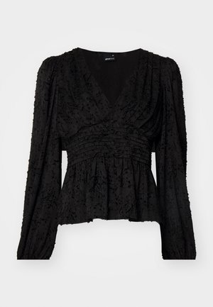 Zwarte blouse met lange mouwen en een diepe V-hals, van textuurstof met een verzamelde taille en een peplum zoom. Kenmerkt zich door complexe details en plooien.