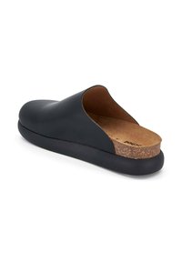 Black leather slip-on shoe with a rounded toe, cork footbed, and a textured black rubber sole. Minimalist design with open back.