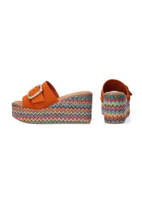 Orange suede wedge sandals with a large silver buckle, featuring a multi-colored woven platform with zigzag pattern. Open back design.