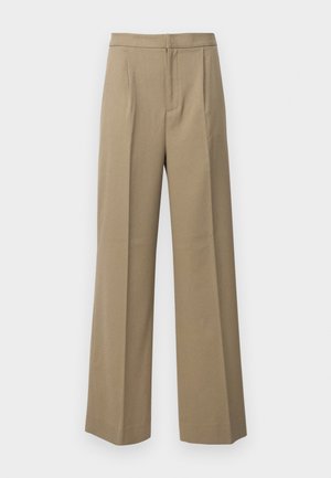 Pantalons larges beige en tissu texturé. Avec des plis sur le devant et une taille plate. Pas de fermetures ni de poches visibles.