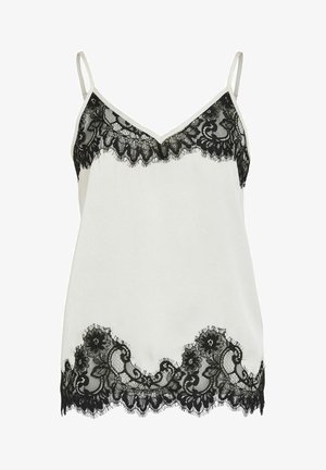 Vitt linne med spets, dekorerat med svarta blomsterliknande spetsdetaljer längs urringningen och nederkanten, med tunna spaghettiband och mjuk textur.