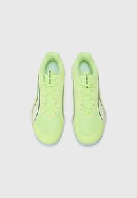 Light green athletic shoes with mesh and synthetic materials, featuring a rounded toe, flat laces, and contrasting dark accents.