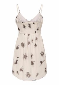 Robe d'été crème avec imprimés floraux noirs et gris, corsage smocké et fines bretelles ajustables.