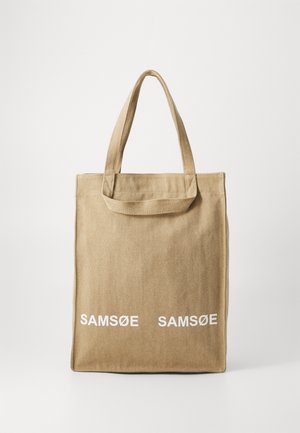 Beež kanvas ostukott kahe õlavarre rihmaga ning valge tekstiga "SAMSUØE", mis on trükitud esiküljele. Lame kuju ja tugev konstruktsioon.