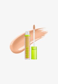 Tube transparente du correcteur NYX professional Makeup Wonder Stick avec bouchon vert vif et applicateur, échantillon de correcteur beige derrière.