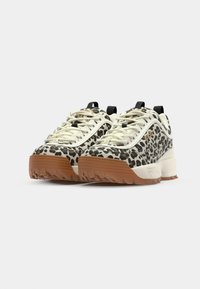 Leopard print sneakers with cream and black accents, featuring a textured rubber sole, lace-up design, and pull tab at the heel.