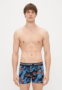 Black boxer shorts with a tropical pattern of blue leaves and orange flowers, featuring a wide elastic waistband with "JACK & JONES" branding.