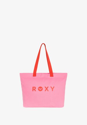 Pink canvas tote bag with red straps, featuring the word "ROXY" in orange. Simple rectangular shape, no patterns or additional details.