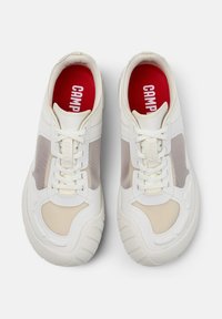 White rubber sneakers feature a rounded shape, mesh side panels, cream accents, and red insoles with "CAMP" printed in white.