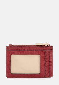Red textured leather cardholder with clear ID window, two card slots, and gold zipper pocket on top against white background.