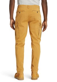 Gula cargo-byxor med sidfickor, normal passform och något avsmalnande ben. Tillverkade av bomull med en slät textur.