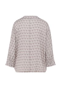 Leichte, beige Bluse mit einem geometrischen Muster in Weiß, im lässigen Schnitt, mit herunterfallenden Schultern und einem gerafften Saum an der Taille.