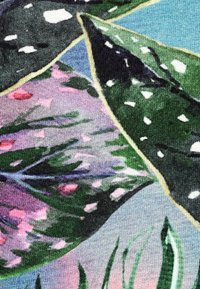 Multicolored textile featuring green leaves with white spots and pink accents. Background has a gradient of blue and light purple.