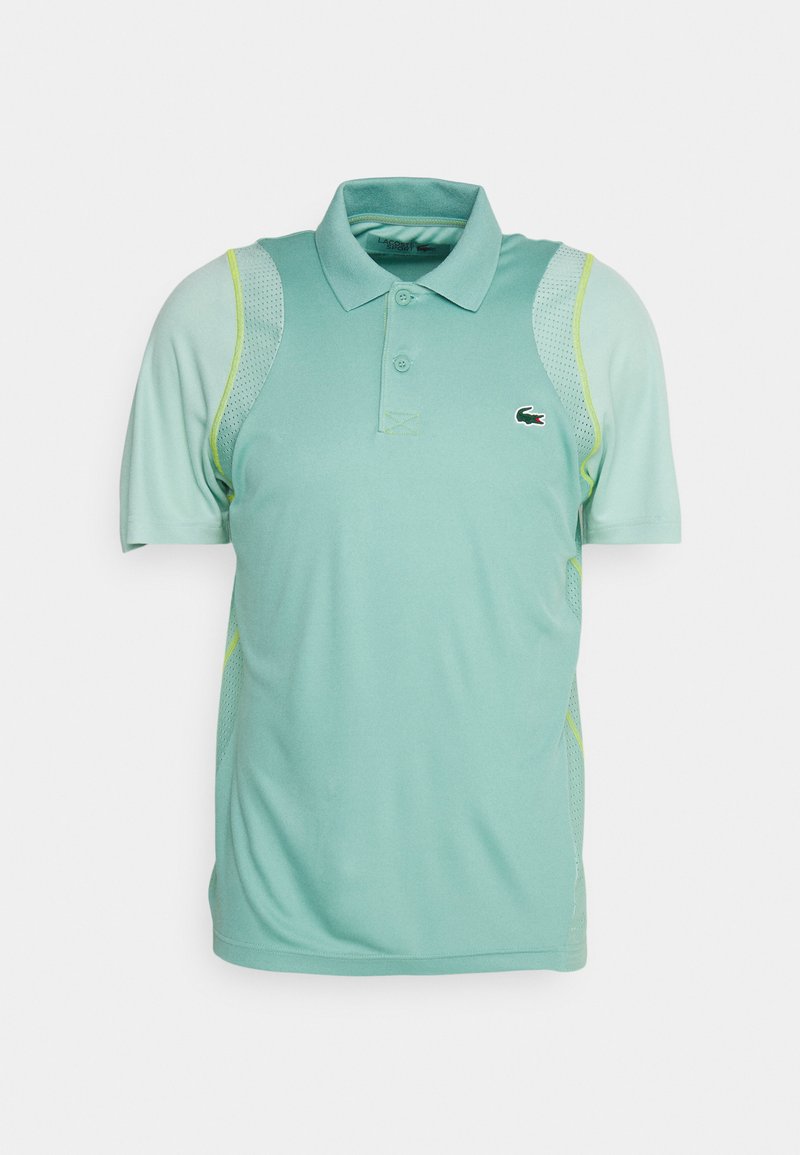 Polo shirt vert clair avec un col, des manches courtes, des panneaux latéraux en mesh et un petit logo brodé sur la poitrine.