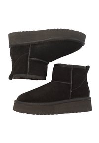 Black suede ankle boots with a flat rubber sole, featuring stitched accents and a soft interior lining, designed for comfort and warmth.