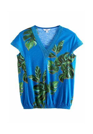 Blue short-sleeve top with V-neck, featuring large green tropical leaf prints and a gathered hem. Lace detailing on the neckline.
