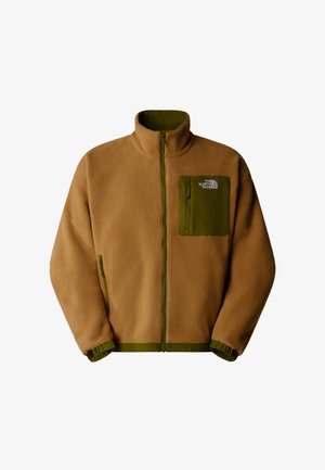 Giacca in pile marrone con una tasca sul petto con zip verde. Presenta un colletto alto, polsini elasticizzati e dettagli in zip verde coordinati.