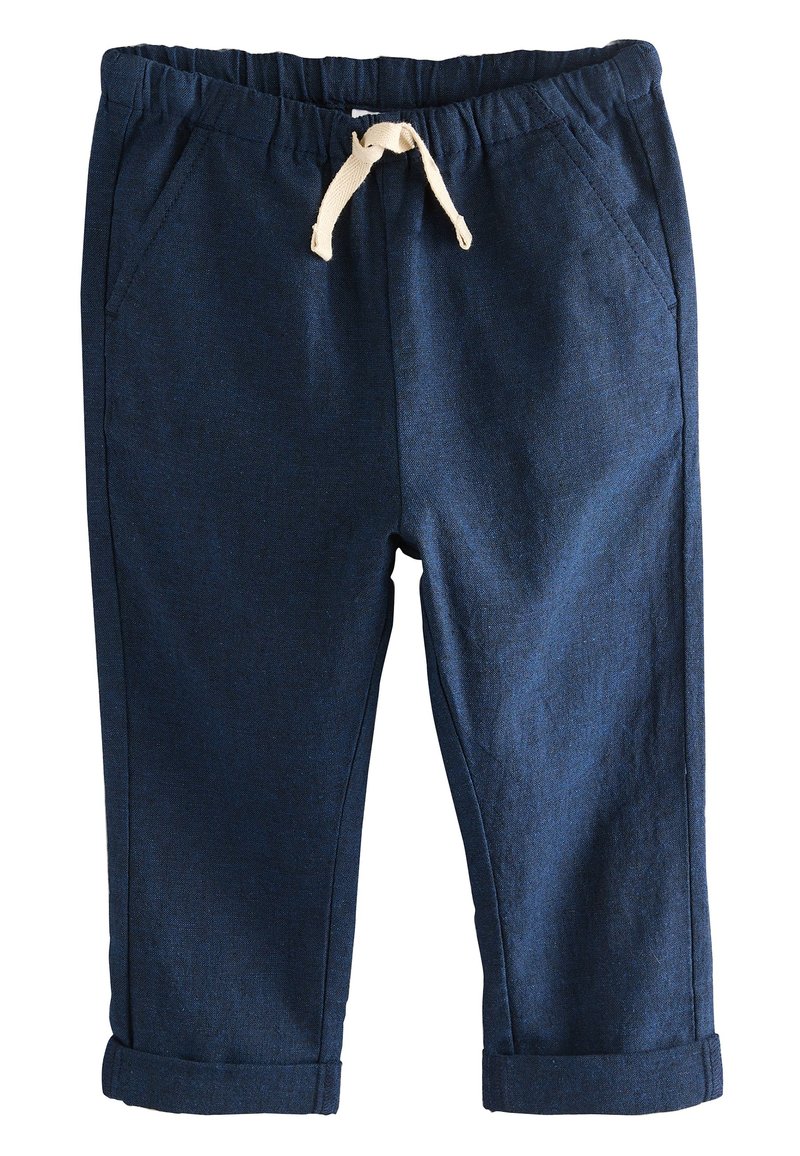 Mørkeblå bukser i blødt stof med elastisk talje og cremefarvet snøre. Har sidelommer og opkrogede kanter ved anklerne.