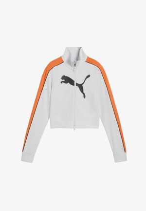 Witte jas met ritssluiting, oranje accenten op de schouders, zwarte zijstrepen en een zwart Puma-logo. Kort model met geribbelde manchetten en kraag.