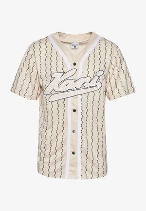 Korte mouwen, beige honkbaljersey met zwarte golvende lijnen, knopen aan de voorkant en een opvallend wit logo. Heeft een witte bies langs de halslijn.
