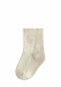 Helle beige gestrickte Socke mit einem feinen Goldfaden, gewelltem oberen Rand und weichem Material. Mittlere Wadenlänge, mit nahtlosem Zehenbereich.