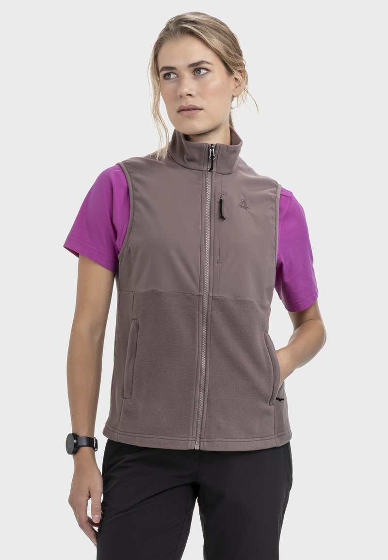 Ärmellose graue Fleeceweste mit hohem Kragen, Reißverschluss und Seitentaschen über einem kurzärmeligen, leuchtend pinken Shirt. Verstellbarer Saum.