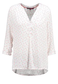 Blouse blanche à col en V, ornée d'un motif d'étoiles rose clair, manches longues retroussées jusqu'au trois-quarts, avec une poche sur le devant.